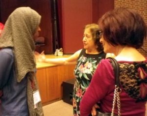 Joyce Fairchild talking with conference attendees.