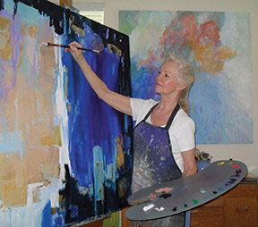 Dorate Muller paints in her studio.