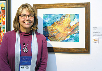 artist in front of painting