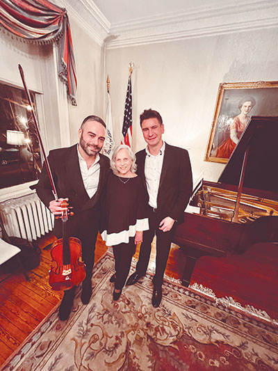 President Evelyn Wofford with Washington Arts Ensemble co-founder and pianist Christopher Schmitt (right) and violinist Jesus Rodolfo during the ensemble’s performance at Pen Arts.