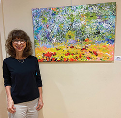 artist in front of painting