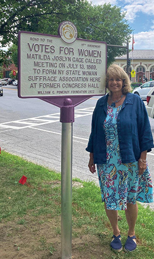 Woman in front of sign