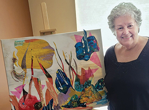 artist in front of her work