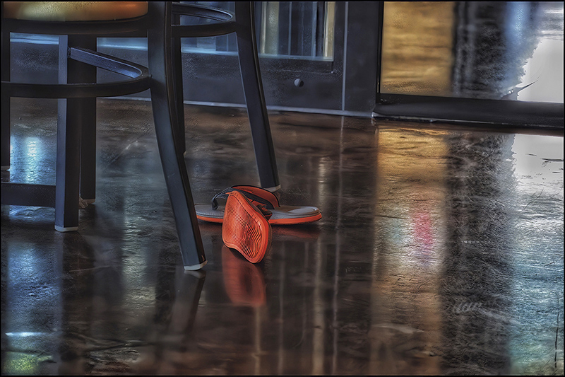 photo of flip-flops on the floor in the middle of a room